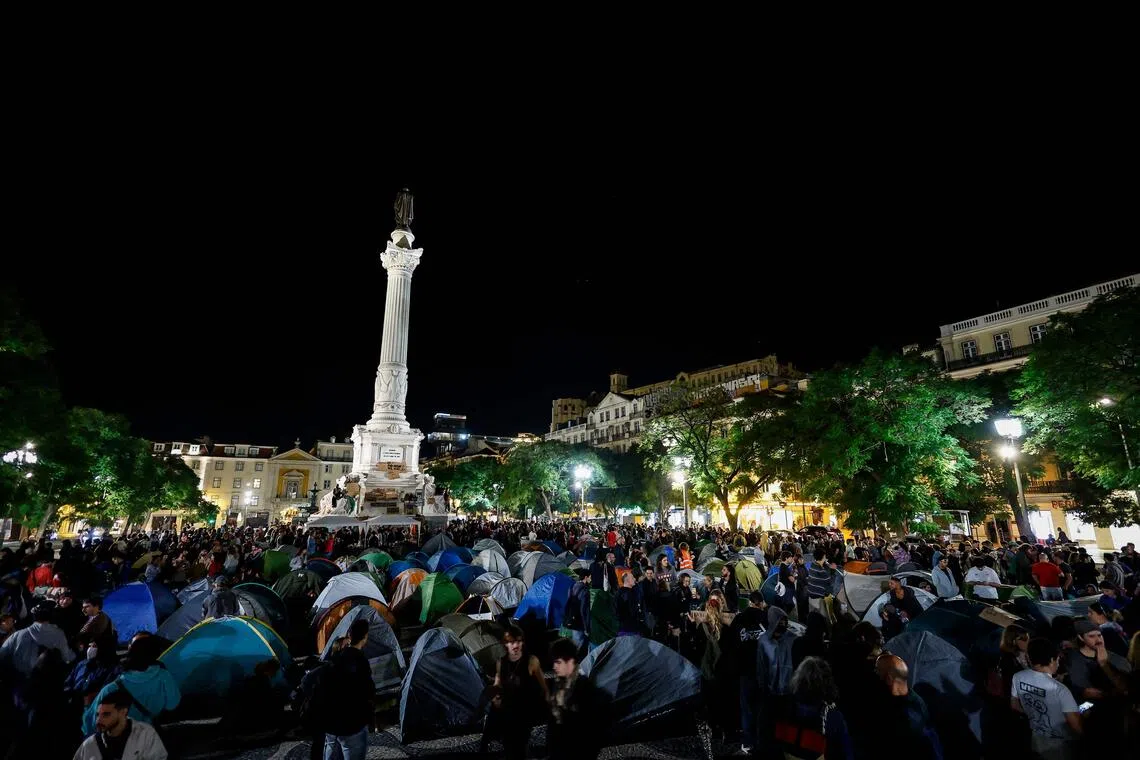 Demonstrators set up tents to protest against housing shortage, soaring rents and low wages on Rossio square in central Lisbon on Oct 18.