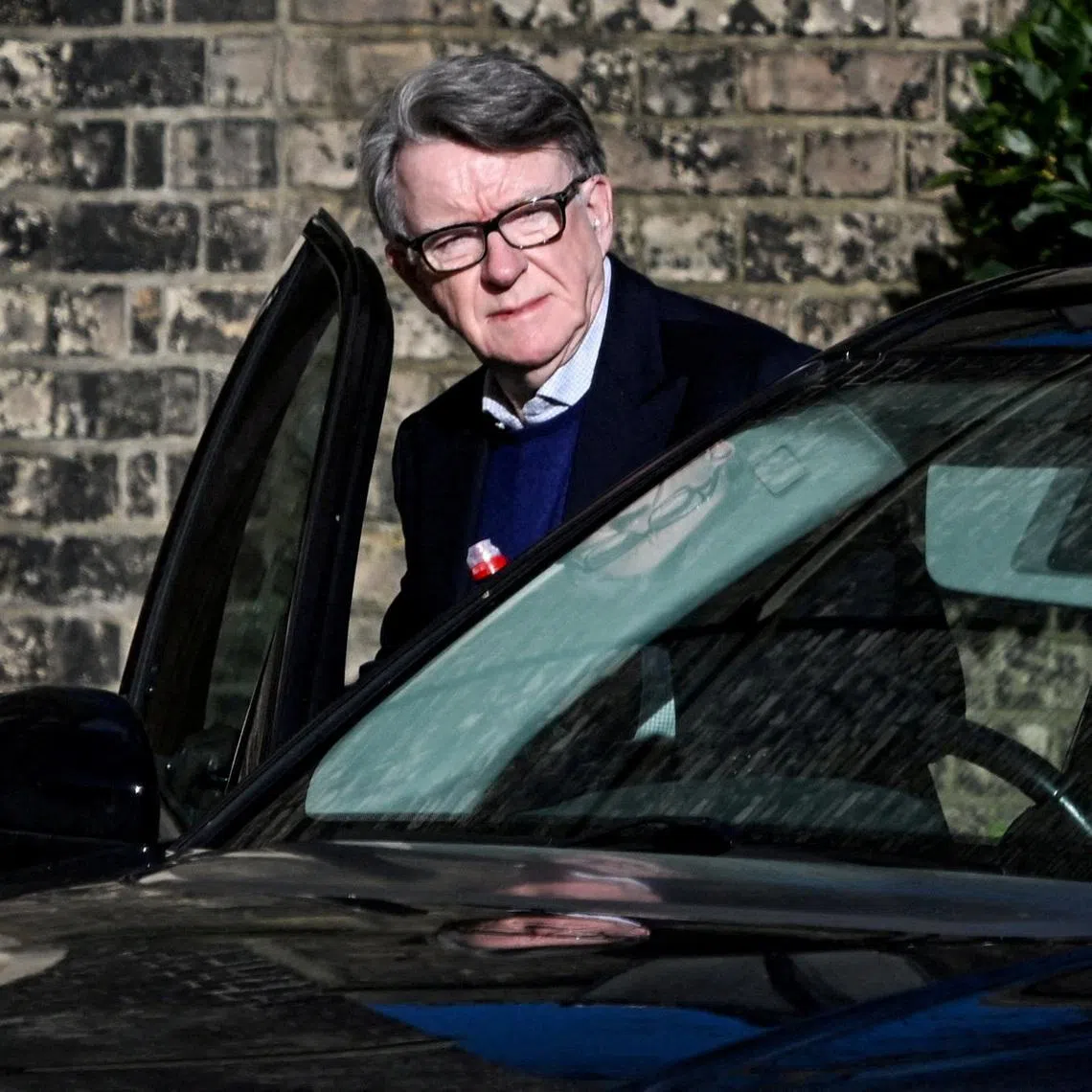 FILE PHOTO: Former British Ambassador to the U.S. Peter Mandelson enters a vehicle outside a reported residence, after police launched a misconduct in public office investigation following the release of U.S. Justice Department files linked to the late financier and convicted sex offender Jeffrey Epstein, in London, Britain, February 14, 2026. REUTERS/Chris Ratcliffe
