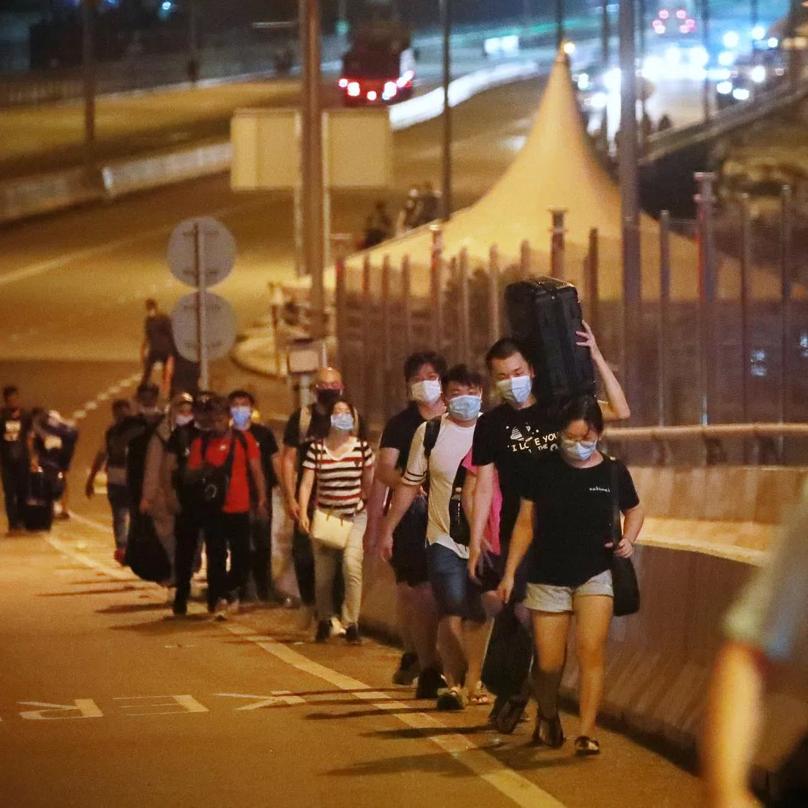 People walking across the Causeway to Johor Bahru after the land borders between Singapore and Malaysia fully reopened at midnight on April 1, 2022.