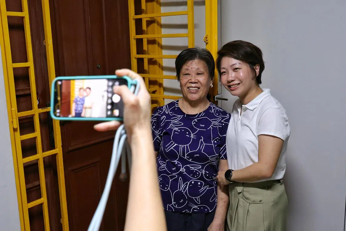 The PAP's Mountbatten SMC candidate Gho Sze Kee with a resident during house visits in Jalan Tiga on April 21.