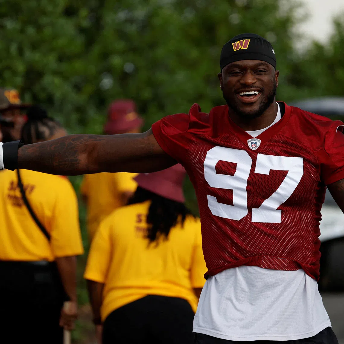 FILE PHOTO: Jul 27, 2023; Ashburn, VA, USA; Washington Commanders defensive end Efe Obada (97) gestures to fans while walking to the fields on day two of Commanders training camp at OrthoVirginia Training Center. Mandatory Credit: Geoff Burke-USA TODAY Sports/File Photo