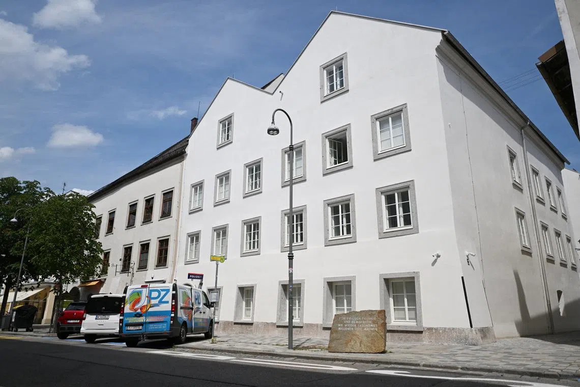Vehicles are parked outside the building where Adolf Hitler was born, which has been converted into a police station by Austria's government in hopes of preventing it from serving as a place of ‌pilgrimage for neo-Nazis, in Braunau am Inn, Austria, July 16, 2026. REUTERS/Angelika Warmuth