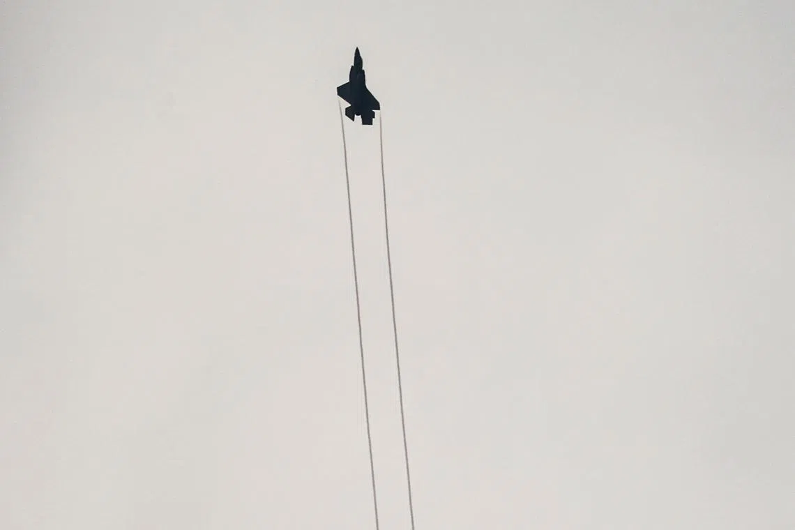 FILE PHOTO: An Israeli F-35 combat aircraft is seen in the skies over Israel's border with Lebanon, in northern Israel, October 9, 2023. REUTERS/Ammar Awad/File Photo