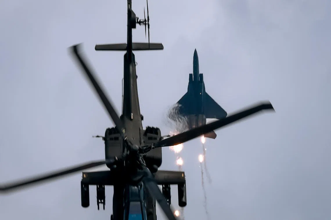 The Republic of Singapore Air Force performing in their F-15SG & AH-64D during an aerial display at the Singapore Airshow held at Changi Exhibition Centre, Feb 25, 2024.