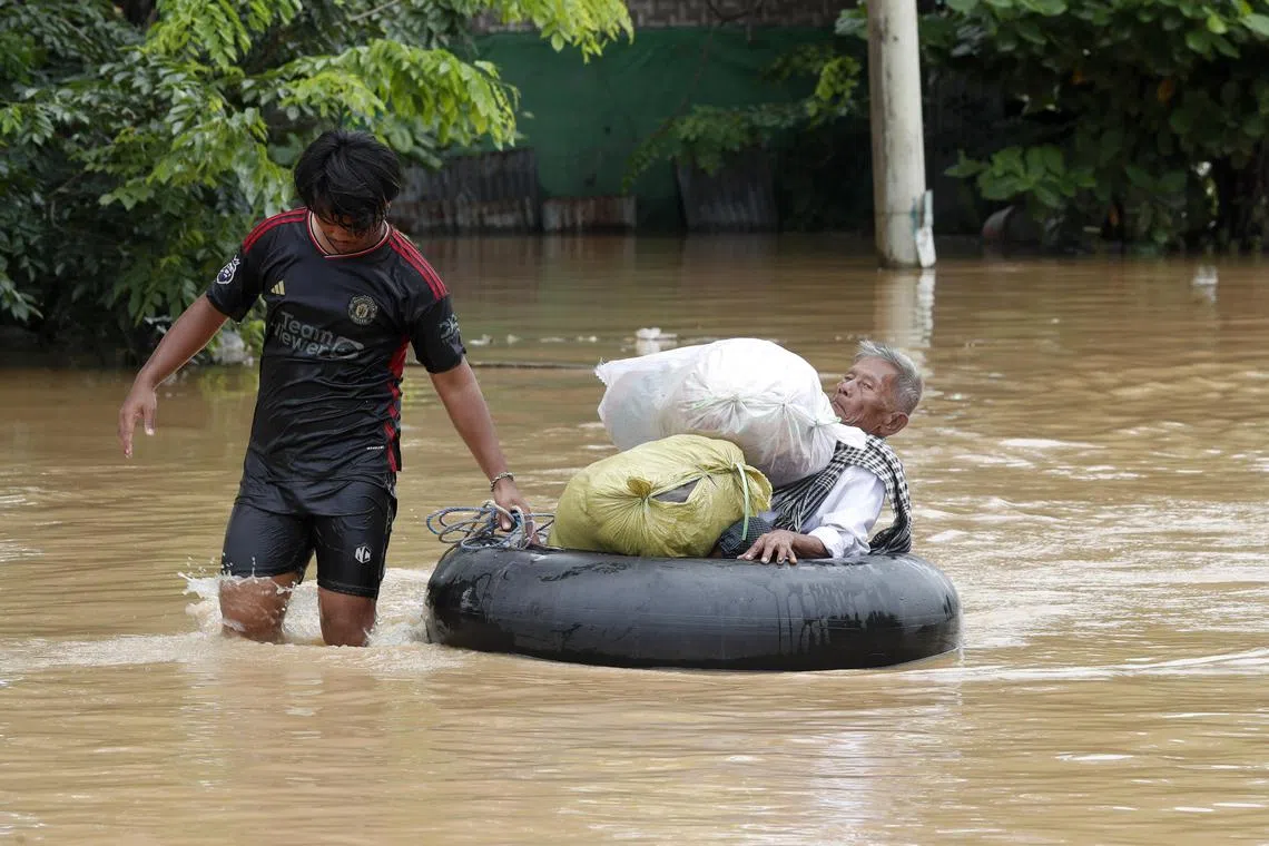 epa11603203 A man carries an elderly man on a tyre tube during the flood in Taungoo, Bago division, Myanmar, 14 September 2024. Heavy rains triggered by Typhoon Yagi have caused severe flooding in parts of Myanmar, leaving thousands stranded in their homes, with further heavy rainfall and thunderstorms expected, according to the state weather office. A statement from the Military announced 59,413 households were affected in 34 townships and set up 187 relief camps for the 236,649 people. There were 33 casualties due to the flood in the country including the Naypyitaw.  EPA-EFE/NYEIN CHAN NAING