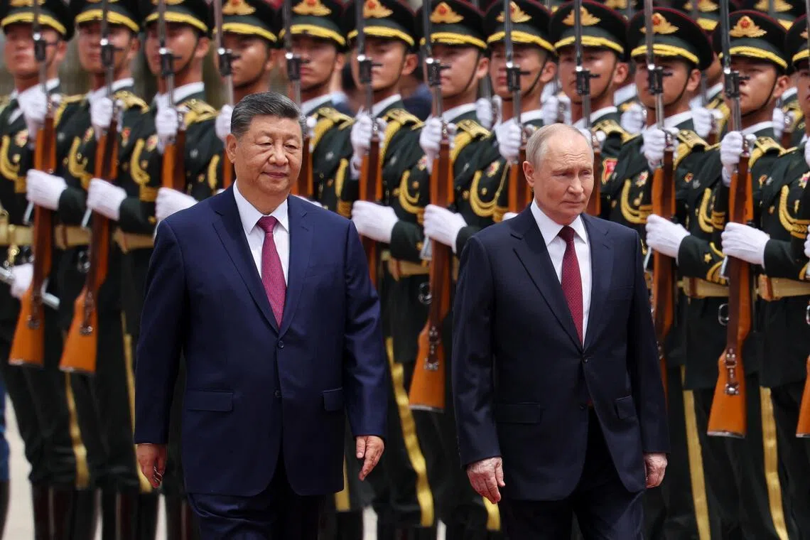 Chinese President Xi Jinping and Russian President Vladimir Putin inspecting an honour guard during a welcome ceremony for Mr Putin in Beijing on May 20.