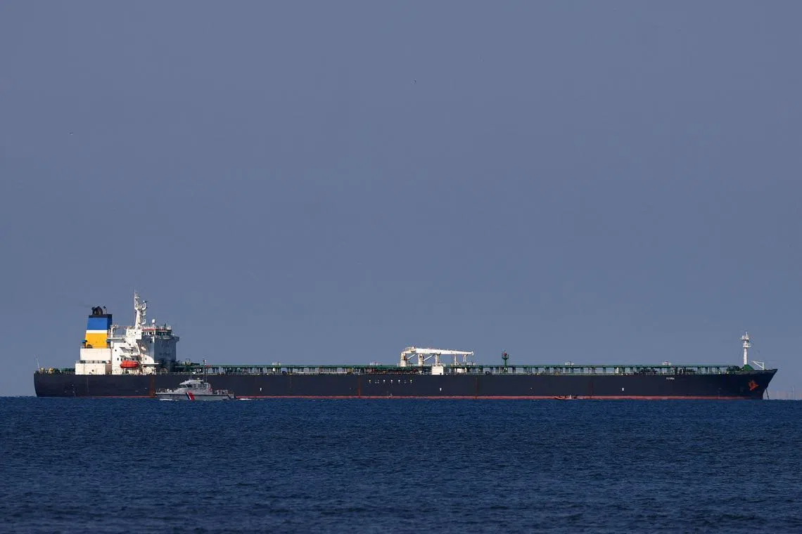 FILE PHOTO: A French Maritime Gendarmerie boat patrols around the Mozambique-flagged oil tanker named Deyna, which France says is part of Russia's shadow fleet, off the port of Marseille-Fos in the Gulf of Fos-sur-Mer, near Martigues, France, March 23, 2026. REUTERS/Manon Cruz/File Photo