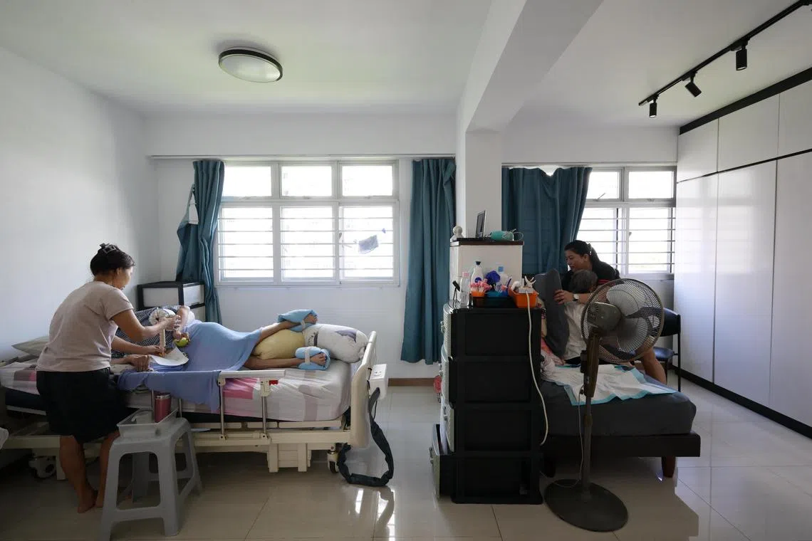 Elderly residents being tended to by their caregivers at home.