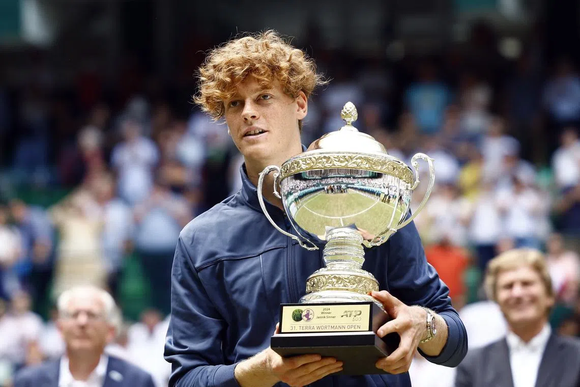 Tennis - Halle Open - OWL Arena, Halle, Germany - June 23, 2024 Italy's Jannik Sinner poses with the trophy after winning the final against Poland's Hubert Hurkacz REUTERS/Leon Kuegeler