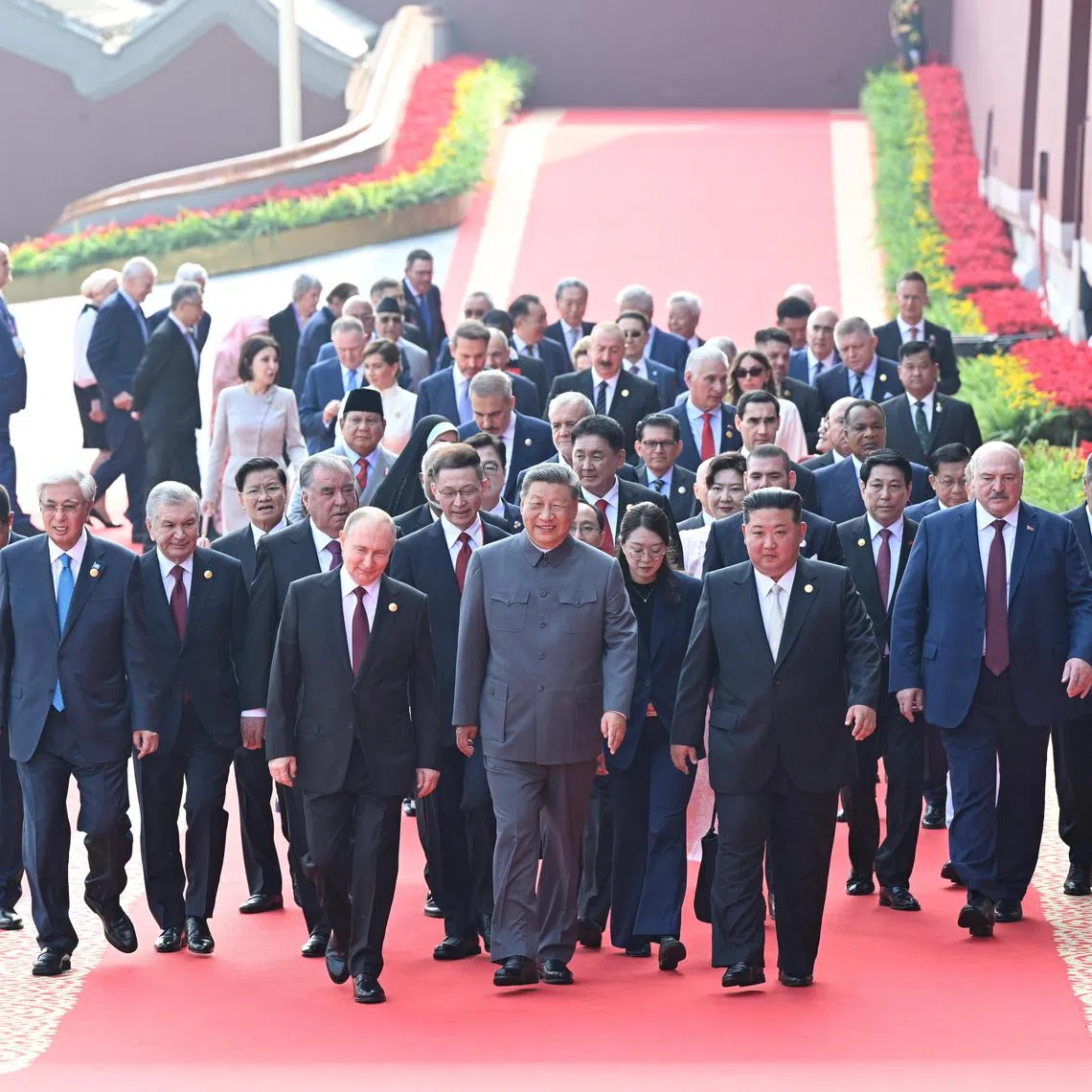 Chinese President Xi Jinping (front centre), Russian President Vladimir Putin (front left), North Korean leader Kim Jong Un (front right) and foreign leaders walk to Tian'anmen Rostruma ahead of a military parade on Sept 3.