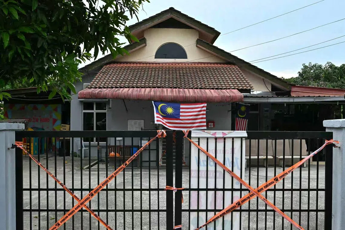 Malaysian Department of Social Welfare tape blocks off gates at the entrance to a care home after a raid by authorities in Subang Jaya outside Kuala Lumpur on Sept 12, 2024.