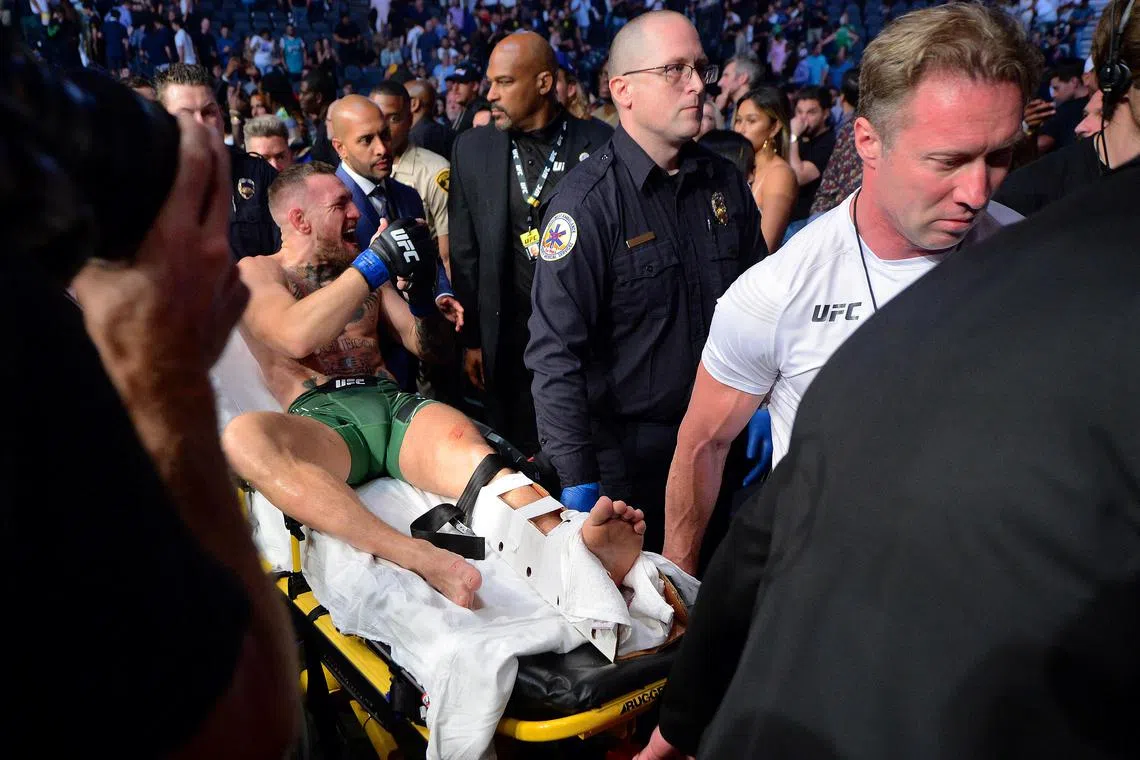 Conor McGregor is carried off on a stretcher after breaking his left leg against Dustin Poirier during UFC 264 at T-Mobile Arena in Las Vegas, Nevada in July 2021.