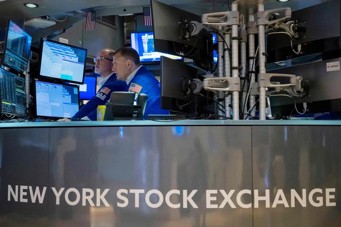 Traders work on the floor of the New York Stock Exchange, in New York City.