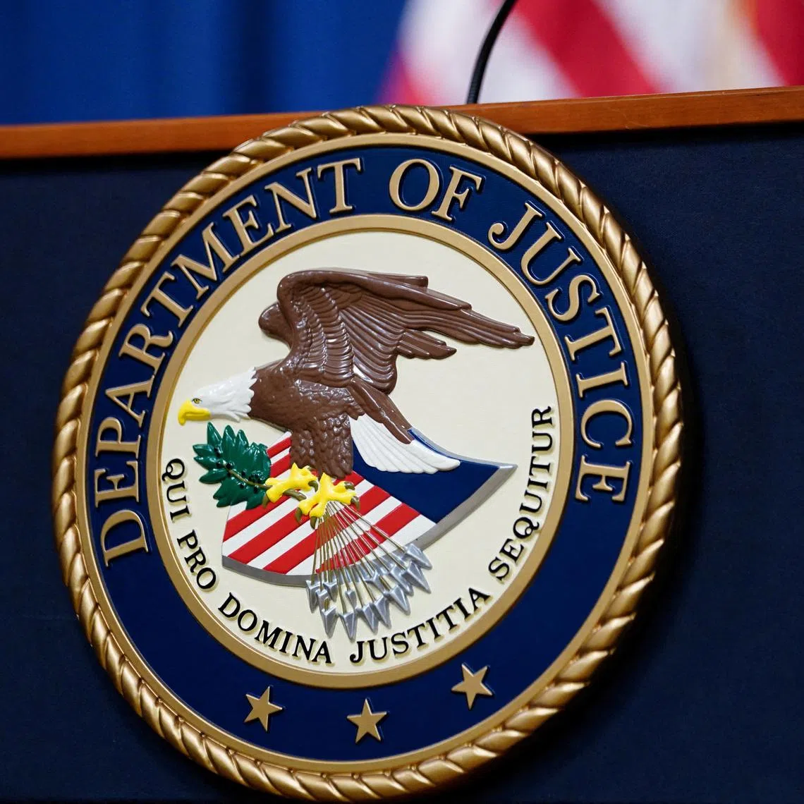 FILE PHOTO: The seal of the U.S. Justice Department is seen on the podium in the Department's headquarters briefing room before a news conference with the Attorney General in Washington, January 24, 2023.  REUTERS/Kevin Lamarque/File Photo