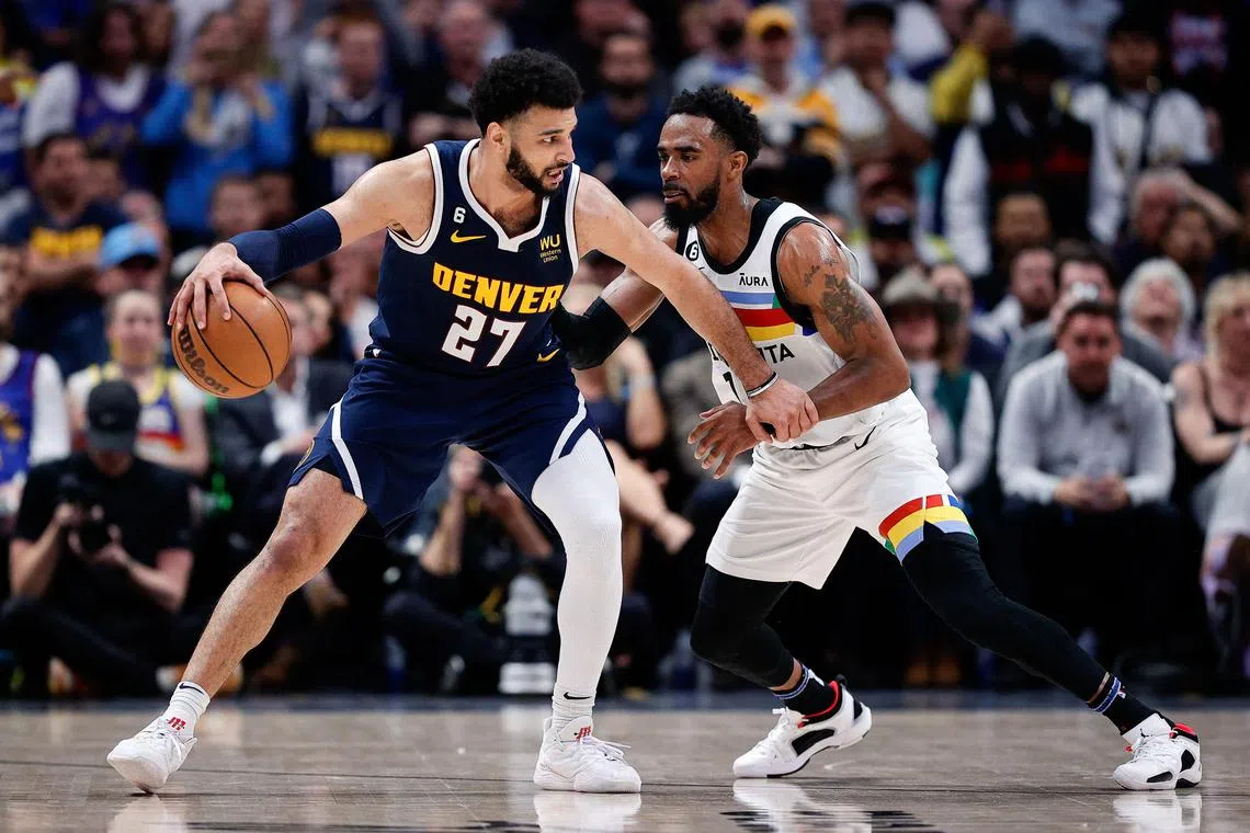 Denver Nuggets guard Jamal Murray controls the ball against Minnesota Timberwolves guard Mike Conley in the fourth quarter of Game 2 of their NBA play-offs.