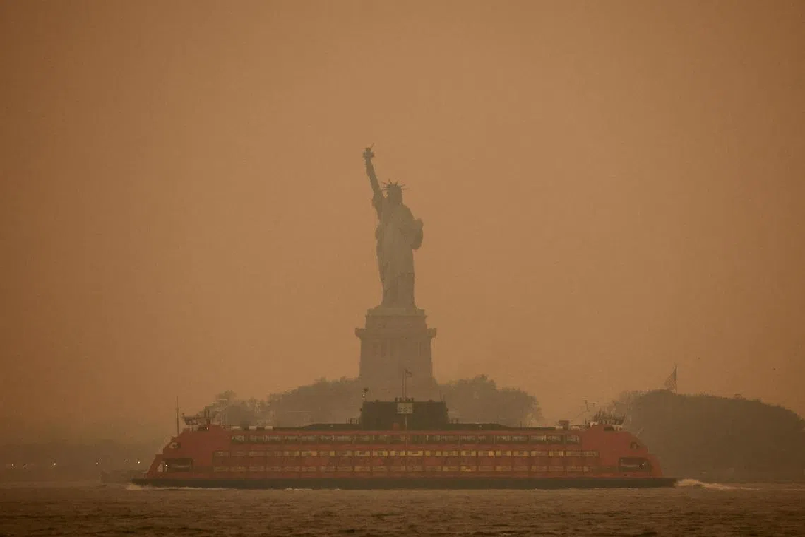 The New York city Statue of Liberty covered in haze and smoke caused by wildfires in Canada, on June 6, 2023. 