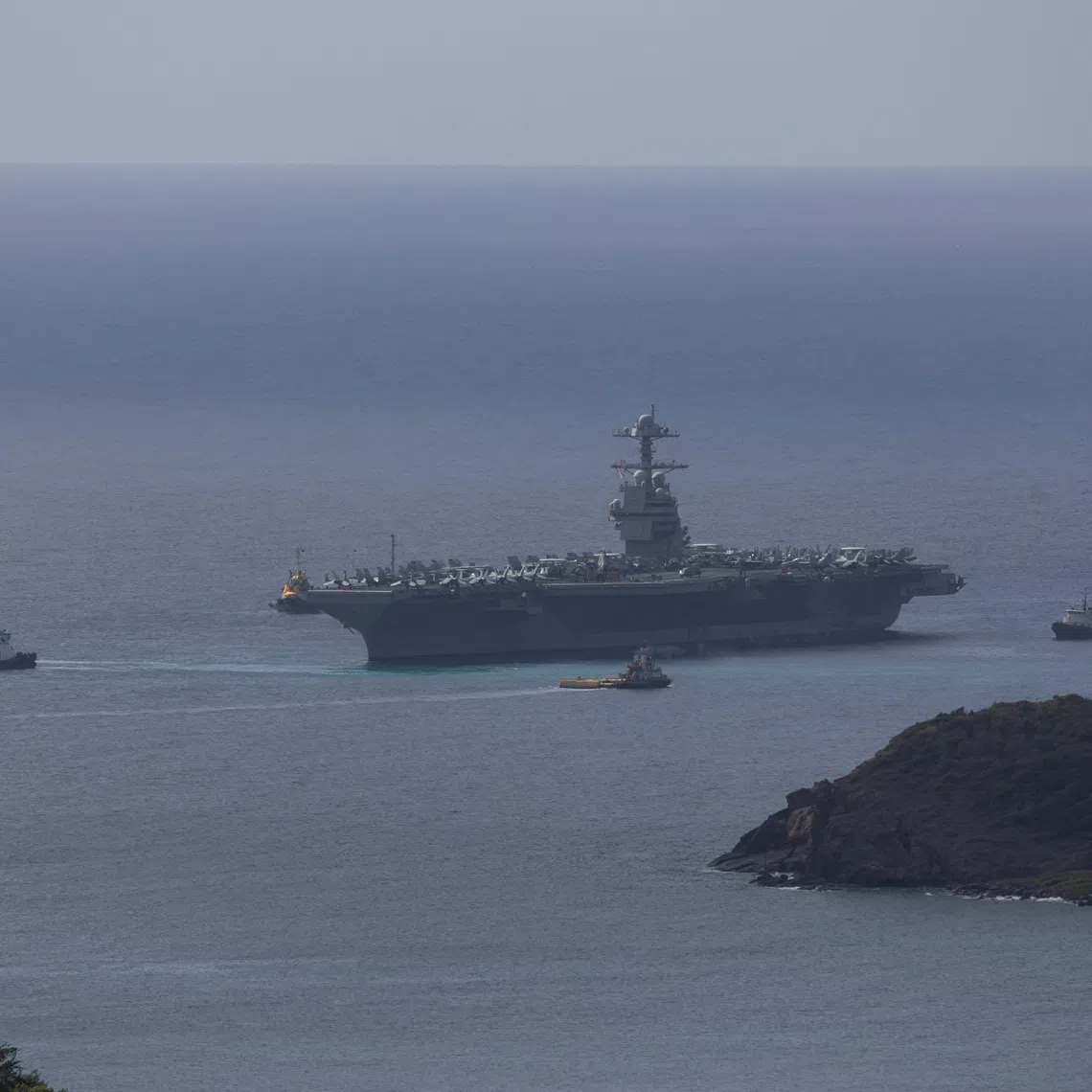 The U.S. Navy USS Gerald R. Ford aircraft carrier (CVN-78) is moved by tug boats near Saint Thomas, U.S. Virgin Islands, December 1, 2025. REUTERS/Marco Bello