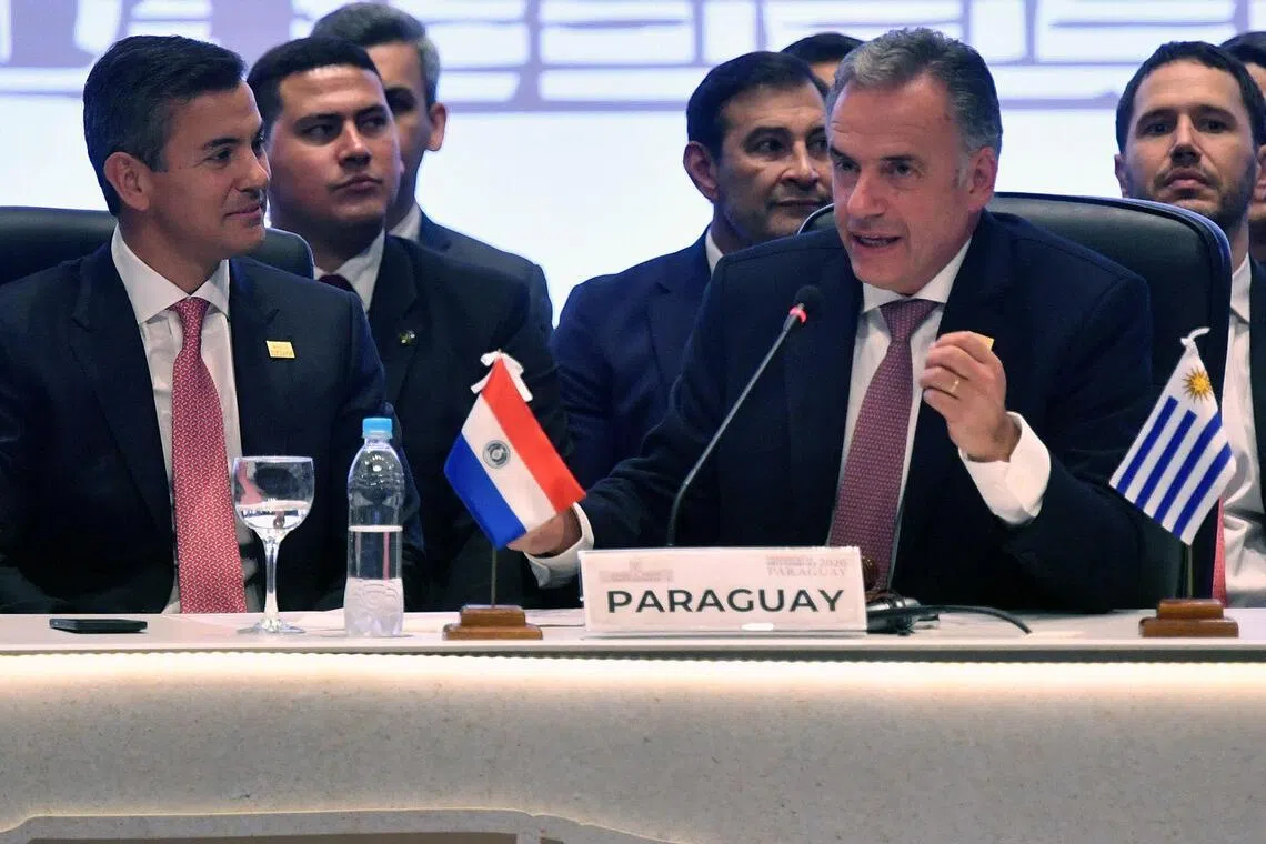 Uruguay's President Yamandu Orsi (R) speaks after passing the pro-tempore presidency to Paraguay's President Santiago Pena during the 68th Mercosur Heads of State summit at the Conmebol headquarters, in Luque, Paraguay on June 30, 2026. (Photo by DANIEL DUARTE / AFP)