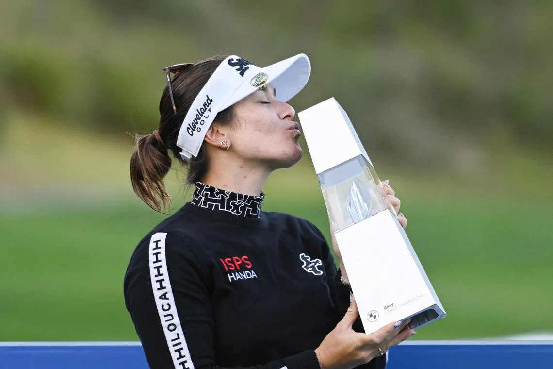 Hannah Green of Australia posing with the champion's trophy after her victory at the 2024 BMW Ladies Championship golf tournament at Seowon Valley Country Club in Paju on Oct 20.