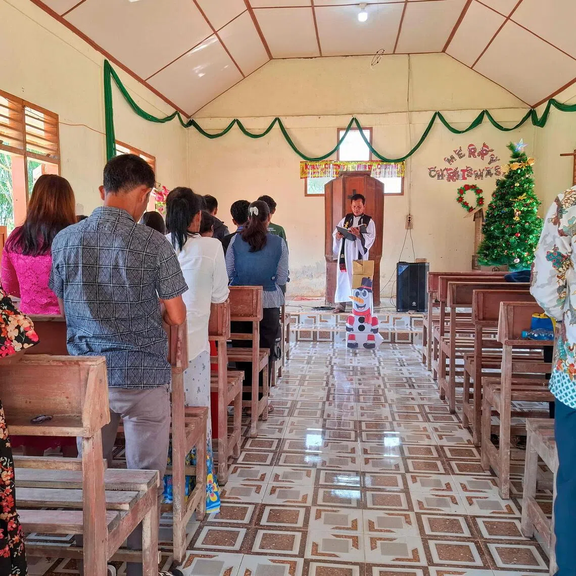 Villagers at Christmas Mass at the Angkola Protestant Church at Aek Ngadol village, South Tapanuli in the aftermath of massive flooding and landslides in the area. 