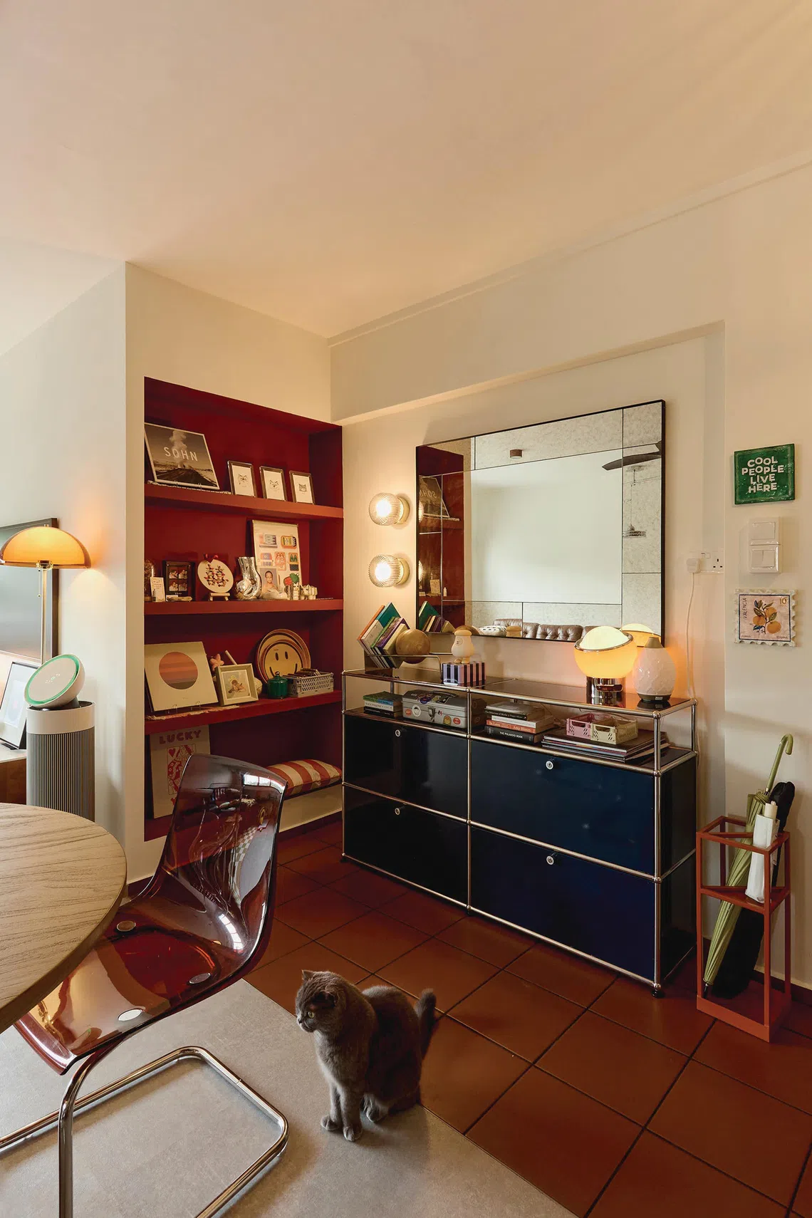 In front of the dining table is a metal bookshelf, lined with a selection of tomes collected on Loh’s travels. 