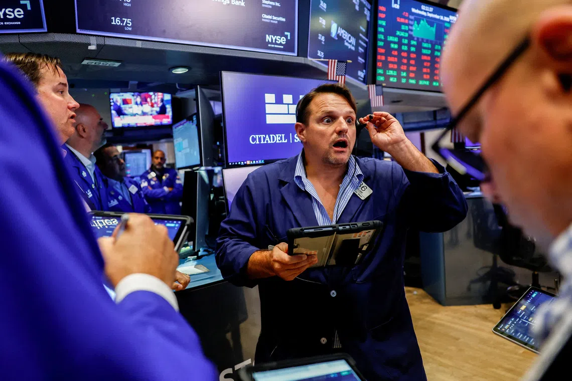 Traders work on the floor of the New York Stock Exchange on Sept 16, in New York City.