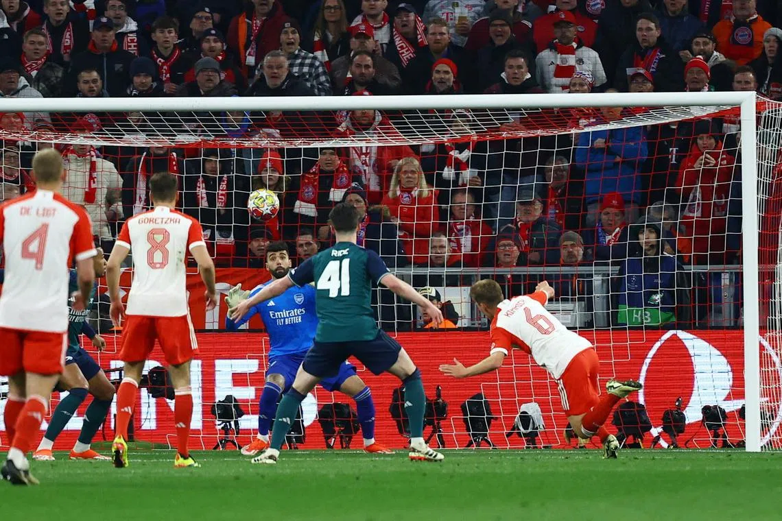 Soccer Football - Champions League - Quarter Final - Second Leg - Bayern Munich v Arsenal - Allianz Arena, Munich, Germany - April 17, 2024 Bayern Munich's Joshua Kimmich scores their first goal past Arsenal's David Raya REUTERS/Kai Pfaffenbach