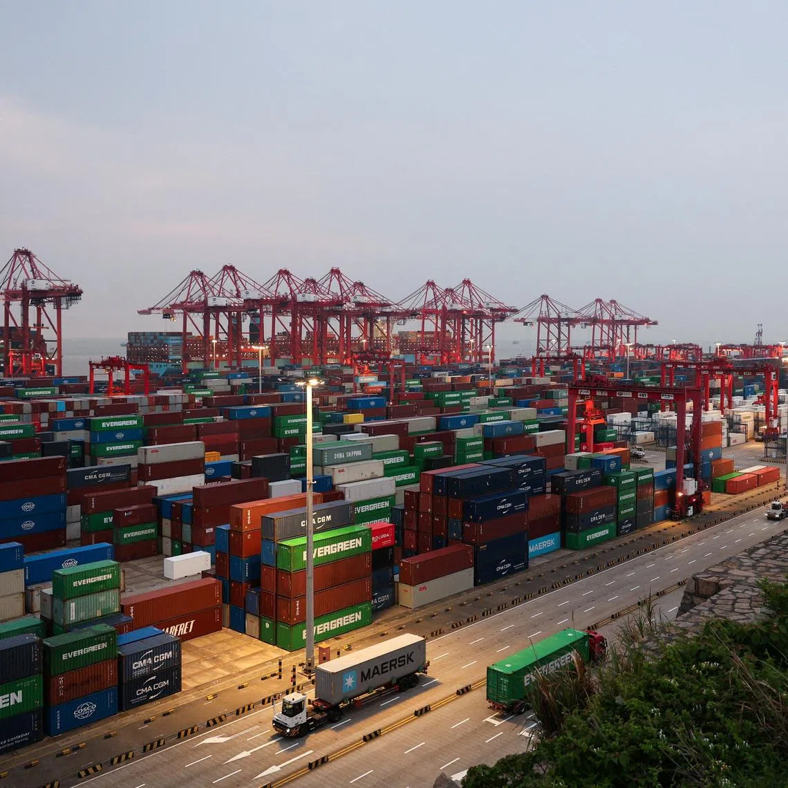 Gantry cranes stand near stacked shipping containers at Yangshan Port outside Shanghai, China, May 7, 2026.  REUTERS/Go Nakamura