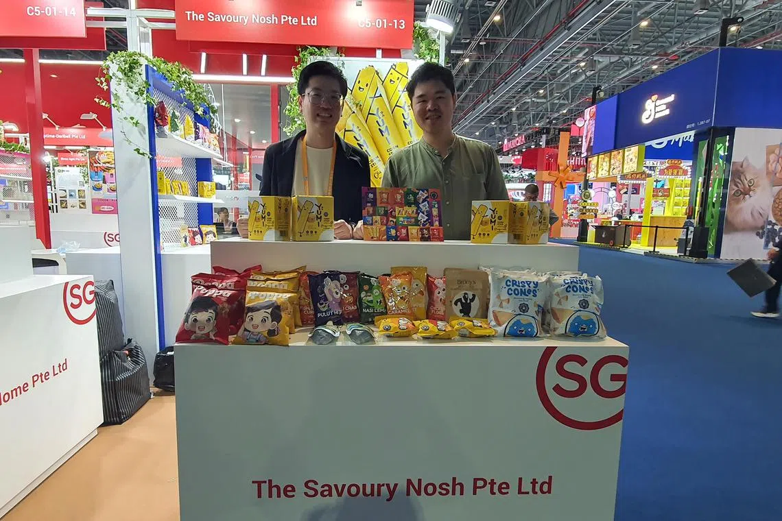Mr Zac Chua (right), founder of The Savoury Nosh, which sells a range of snacks that include popcorn with local flavours. He is pictured with the company's chief financial officer Chan Zi Wei.


ST PHOTO: Joyce ZK Lim