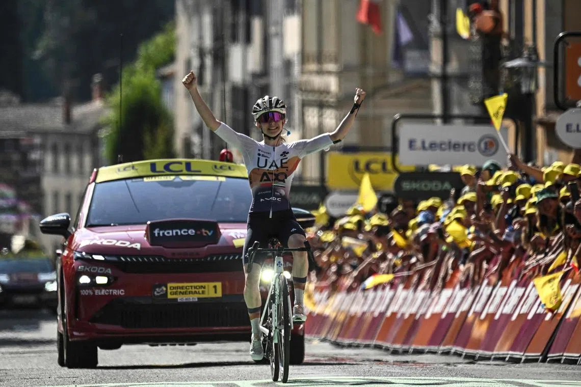 UAE Team ADQ's French rider Maeva Squiban celebrates as she crosses the finish line to win the 6th stage (out of 9) of the fourth edition of the Women's Tour de France cycling race, 123.7 km from Clermont-Ferrand to Ambert in central France on July 31, 2025.