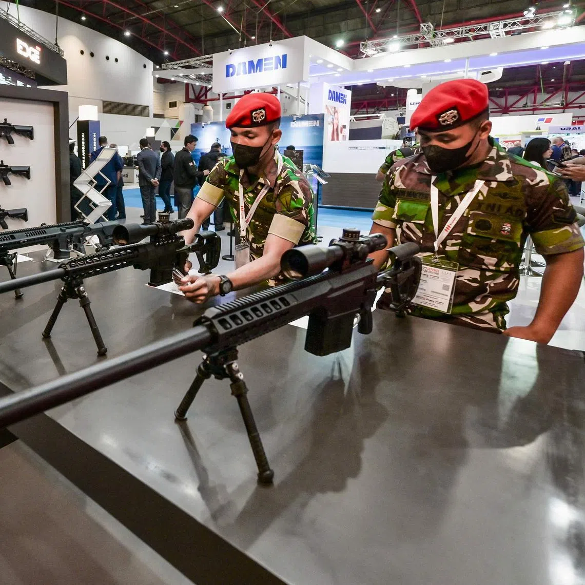 Military officers examining sniper rifles at the Indo Defence Expo in Jakarta on Nov 2, 2022.