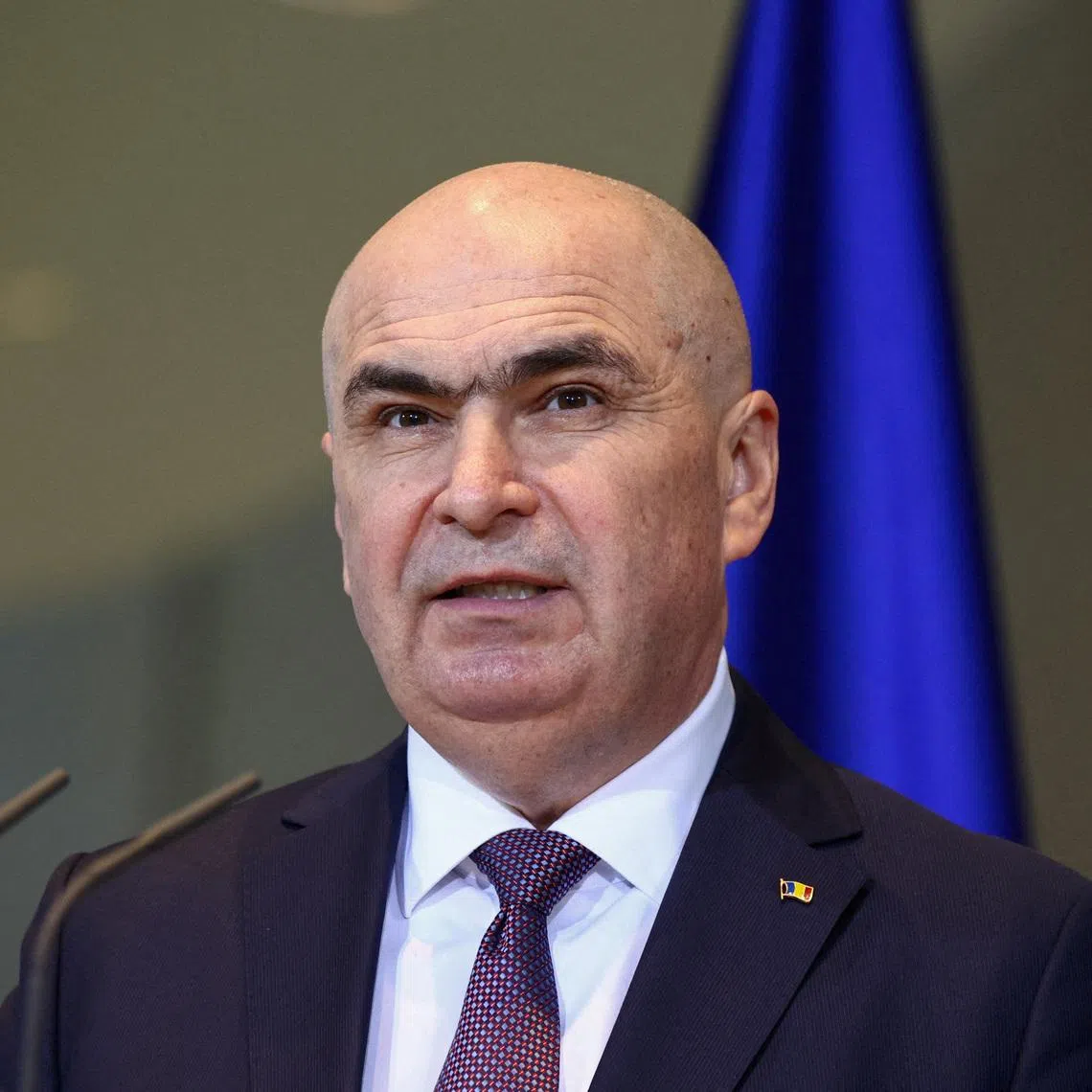 FILE PHOTO: Romanian Prime Minister Ilie Bolojan holds a press conference with German Chancellor Friedrich Merz (not pictured), at the Chancellery, in Berlin, Germany, January 28, 2026. REUTERS/Liesa Johannssen/File Photo