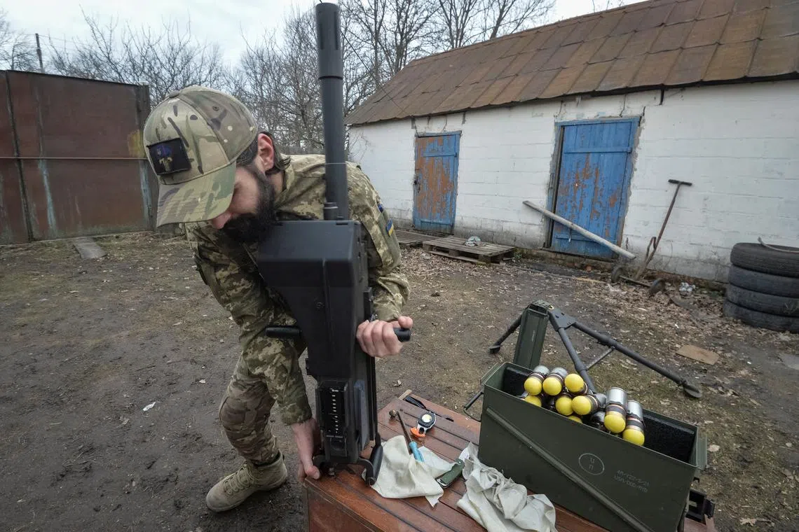 FILE PHOTO: A serviceman of the 57th Separate Motorized Infantry Brigade of the Ukrainian Armed Forces works with an Mk 19 U.S. made automatic grenade launcher, amid Russia's attack on Ukraine, near the frontline town of Vovchansk in the Kharkiv region, Ukraine March 13, 2025. REUTERS/Oleksandr Klymenko/File Photo