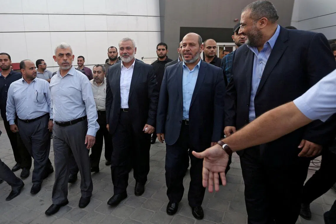 FILE PHOTO: Hamas Gaza Chief Yahya Al-Sinwar, Hamas Chief Ismail Haniyeh and senior Hamas leader Khalil al-Hayya arrive at the Rafah border crossing in the southern Gaza Strip September 19, 2017. REUTERS/Ibraheem Abu Mustafa /File Photo
