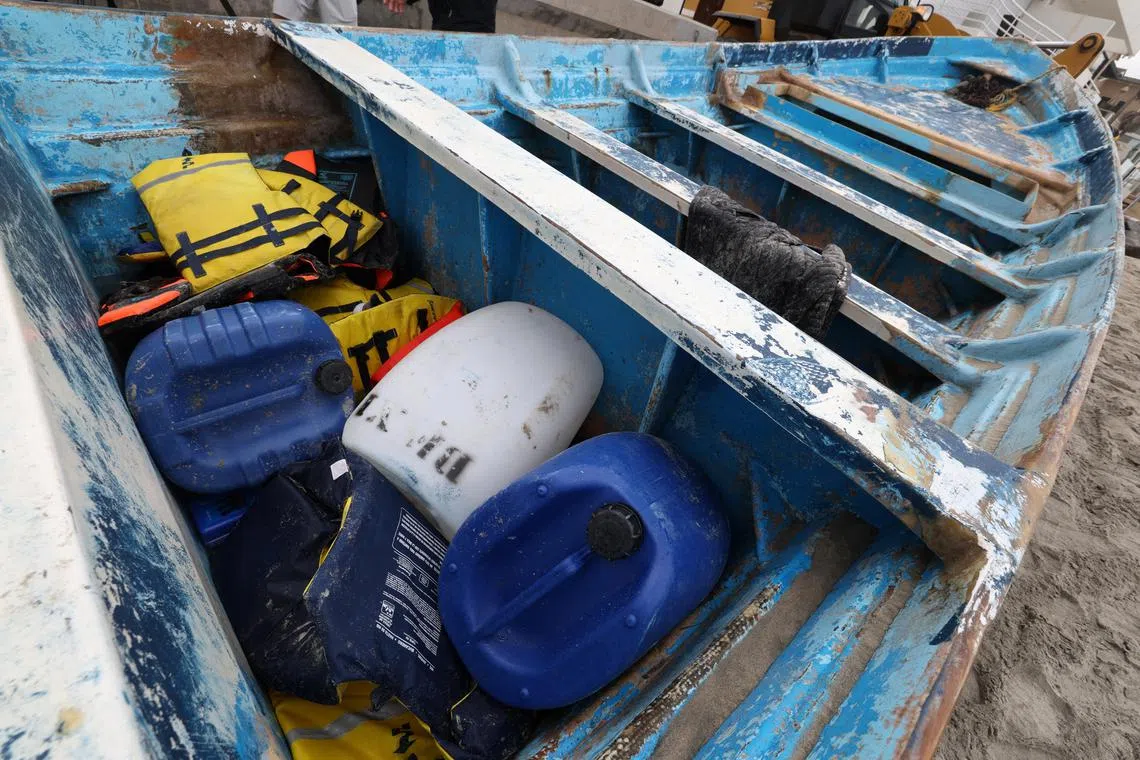 The vessel involved in a deadly Panga boat capsizing off Torrey Pines State Beach sits on the beach after it was dragged from where it came ashore.