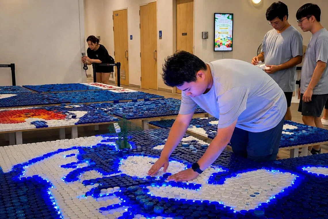 25-year-old youth volunteer Xavier Ang working on the giant map.