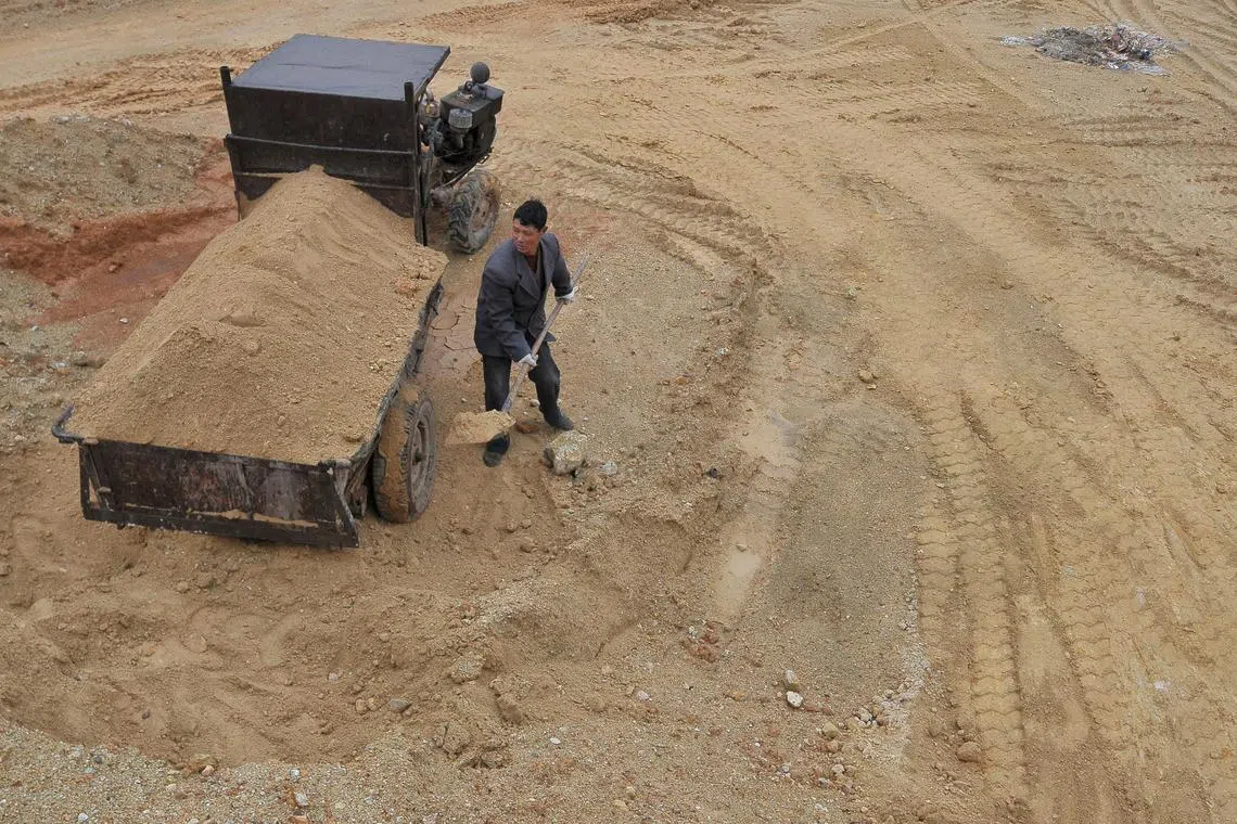 FILE PHOTO: A  labourer works at a site of a rare earth metals mine at Nancheng county, Jiangxi province March 14, 2012. REUTERS/Stringer CHINA OUT. NO COMMERCIAL OR EDITORIAL SALES IN CHINA/File Photo