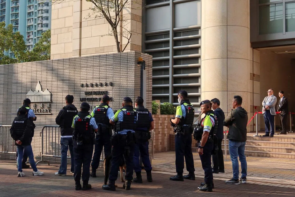 Police stand guard outside the West Kowloon Magistrates' Courts as twelve pro-democracy activists appeal their convictions and sentences in a landmark national security case, in Hong Kong, China, February 23, 2026. REUTERS/Jessie Pang