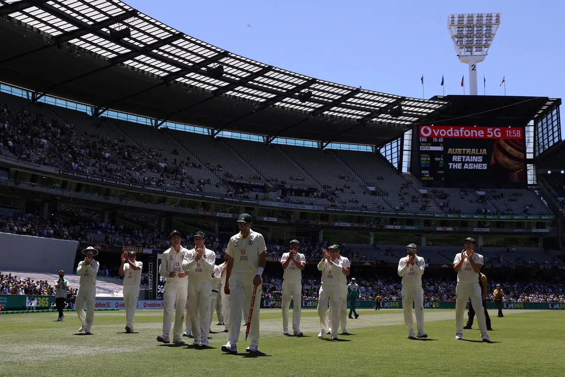 FILE PHOTO: Cricket - Ashes - Third Test - Australia v England - Melbourne Cricket Ground, Melbourne, Australia - December 28, 2021  Australia's Scott Boland celebrates with teammates after winning the match and retaining the Ashes REUTERS/Loren Elliott/File Photo