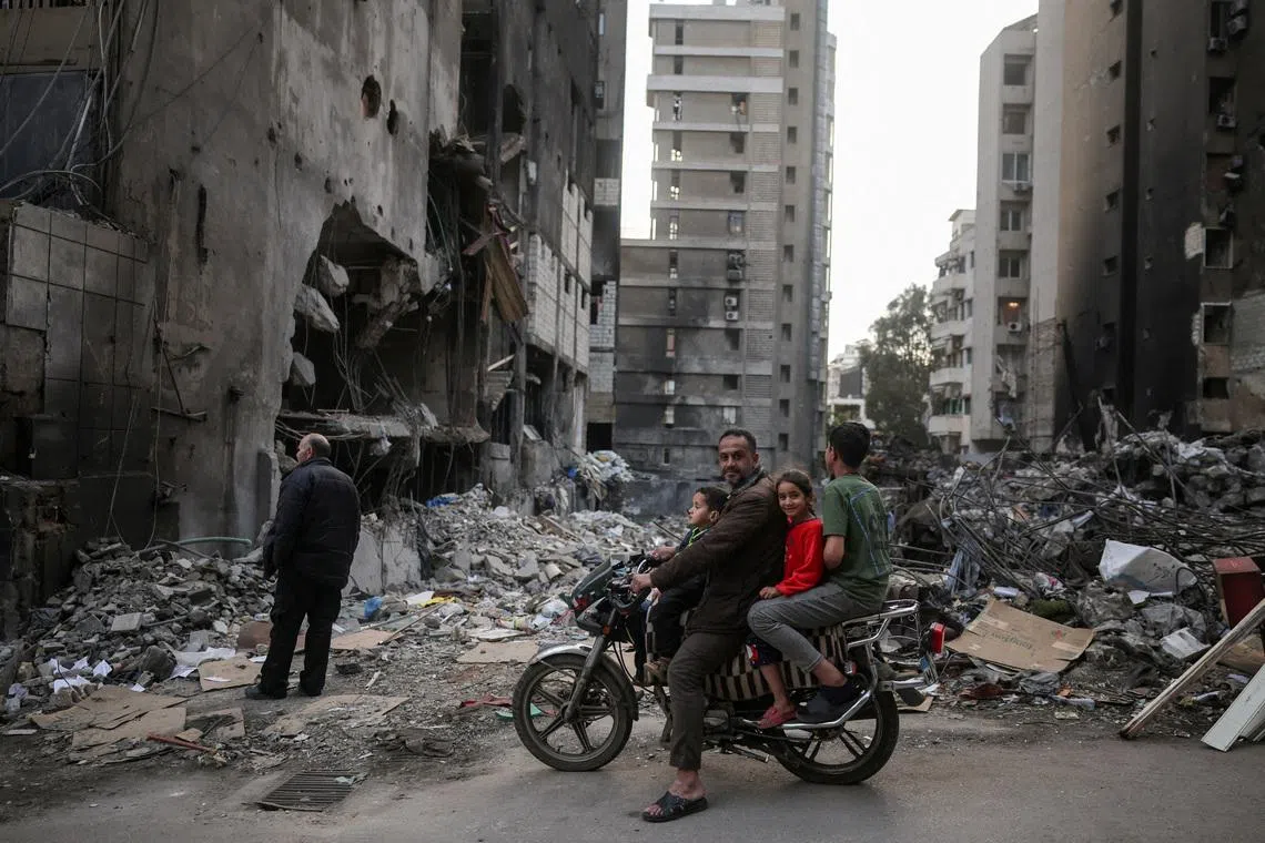 A family visiting the site of an Israeli airstrike, carried out on April 8, following the 10-day ceasefire between Lebanon and Israel, at Corniche al-Mazraa in Beirut, Lebanon, April 19.