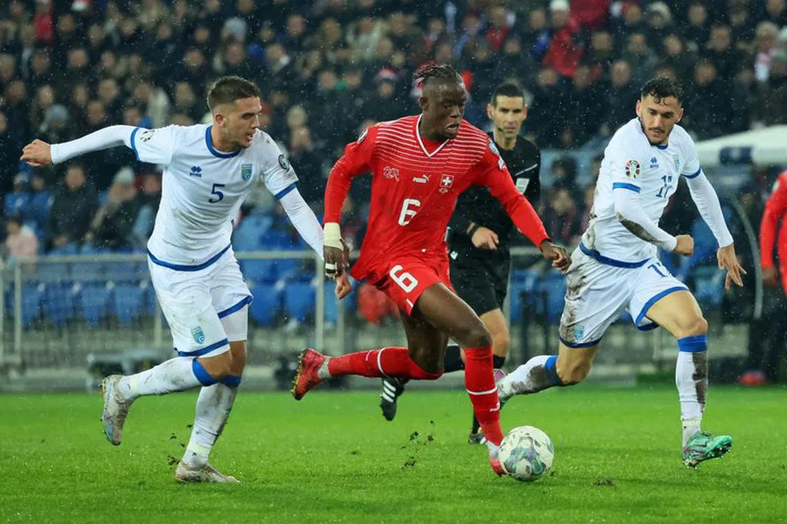 Soccer Football - Euro 2024 Qualifier - Group I - Switzerland v Kosovo - St. Jakob-Park, Basel, Switzerland - November 18, 2023 Kosovo's Ilir Krasniqi in action with Switzerland's Denis Zakaria REUTERS/Denis Balibouse