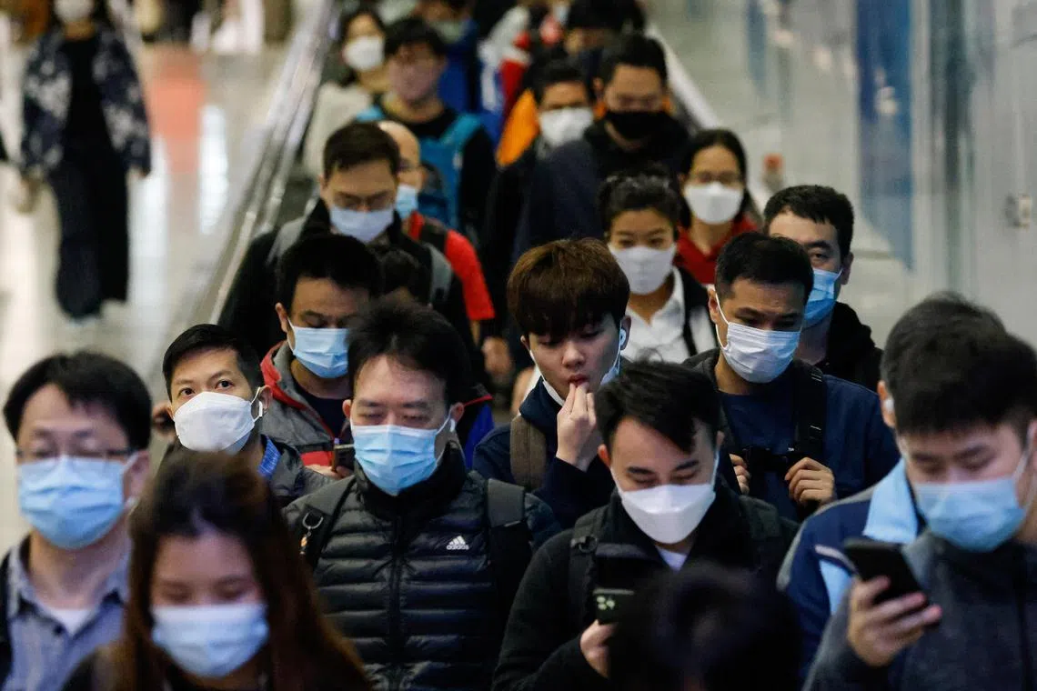 People wear face masks in the MTR station, a day before government scraps the mask rule in Hong Kong, China February 28, 2023. REUTERS/Tyrone Siu