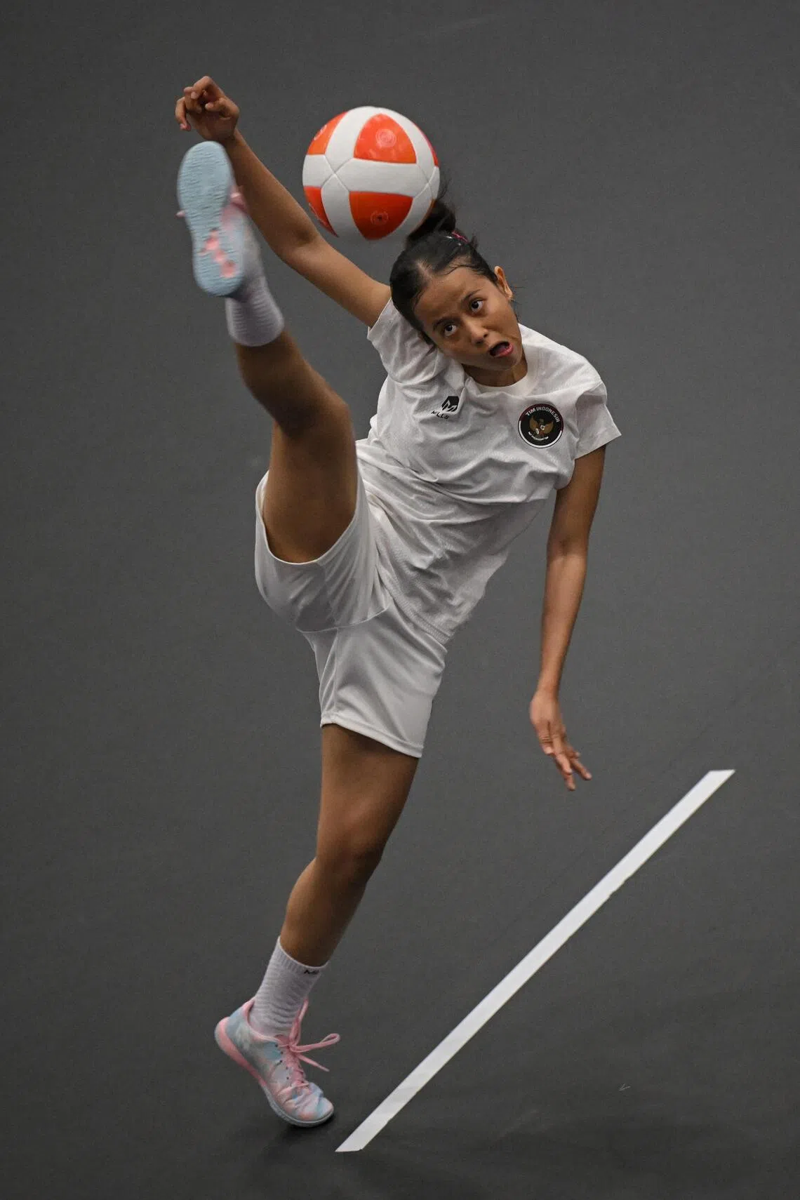 Sumaya of Indonesia in action against Quimcy Joaquim Dsouza of India during the teqball women’s singles semi-finals held at the Nagoya City Higashi Sports Center on Sept 19.