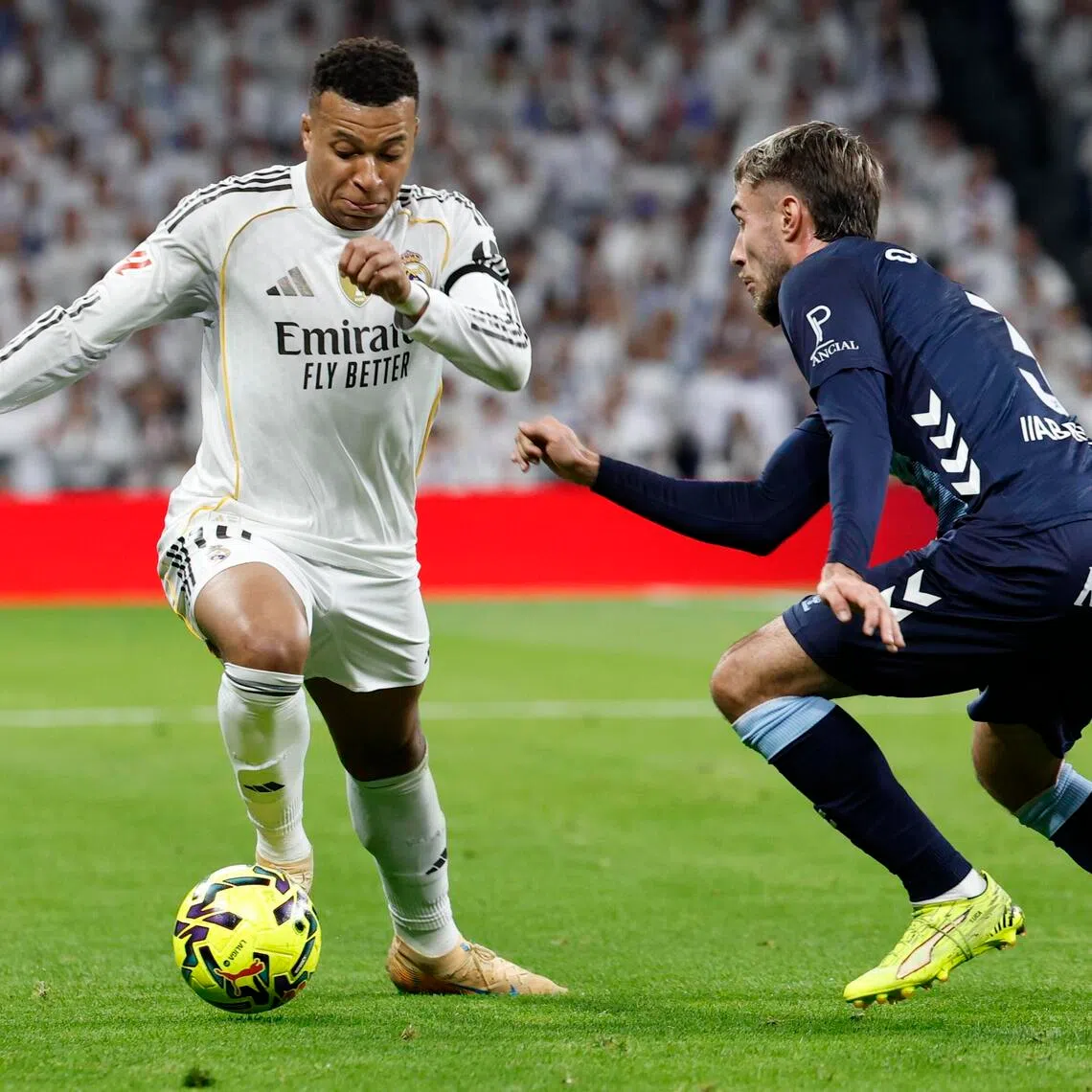 Real Madrid's Kylian Mbappe in action against Celta's Oscar Mingueza during the their La Liga match.