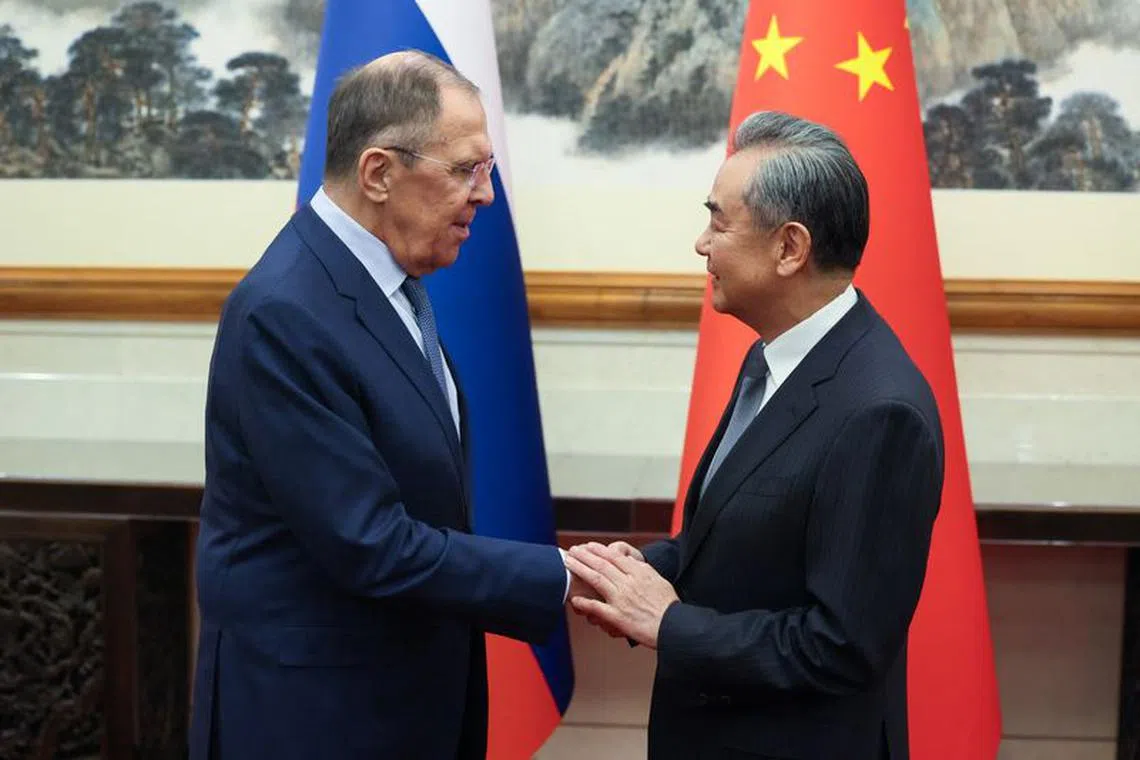 Russian Foreign Minister Sergei Lavrov shakes hands with Chinese Foreign Minister Wang Yi during a meeting in Beijing, China October 16, 2023. Russian Foreign Ministry/Handout via REUTERS