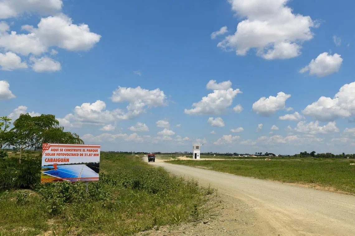 A banner announces the construction of a photovoltaic solar farm in Cabaiguan, Cuba May 21, 2025. REUTERS/Norlys Perez