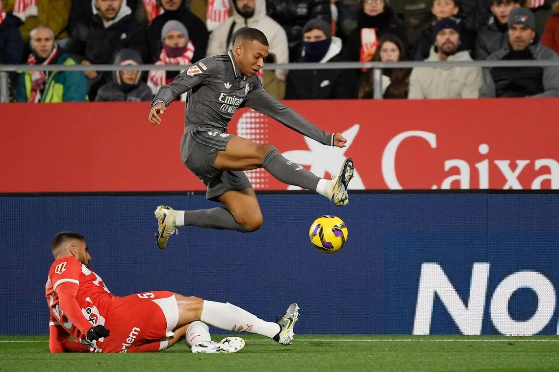 Real Madrid forward Kylian Mbappe and Girona defender David Lopez vie for the ball during their La Liga clash which Real won 3-0.