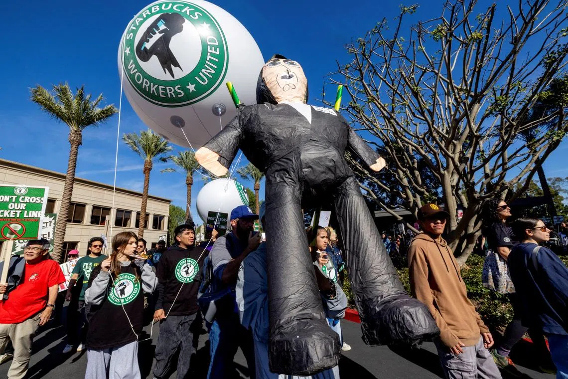 FILE PHOTO: Starbucks baristas and supporters rally outside the company's corporate offices as part of a nationwide push for improved wages and benefits, in Newport Beach, California, U.S. November 24, 2025.  REUTERS/Jill Connelly/File Photo