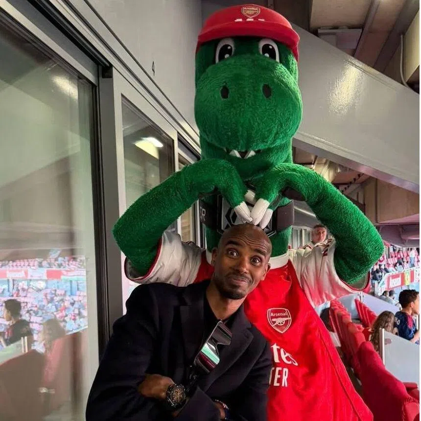 Arsenal fans Mo Farah (left) and Amita Berthier celebrate Arsenal's first Premier League title after 22 years.