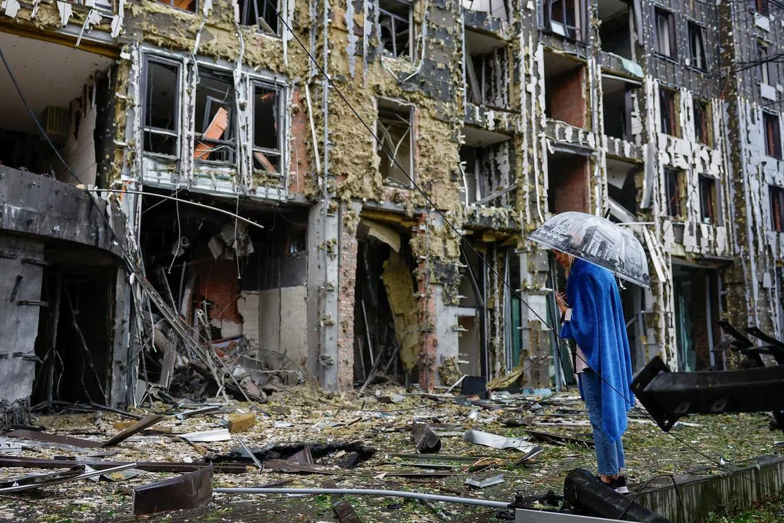 A resident standing in front of an apartment building, which was hit during Russian missile and drone strikes, in Kyiv, Ukraine, on June 15, 2026. 